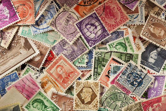 Colorful Vintage Used Postage Stamps in a pile